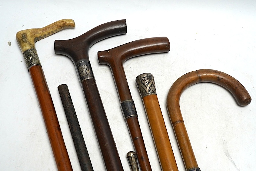 Four mixed silver mounted walking sticks, a riding crop and a baton, longest 88cm. (6). Condition - fair considering use and age